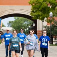 Individuals near finish line walking